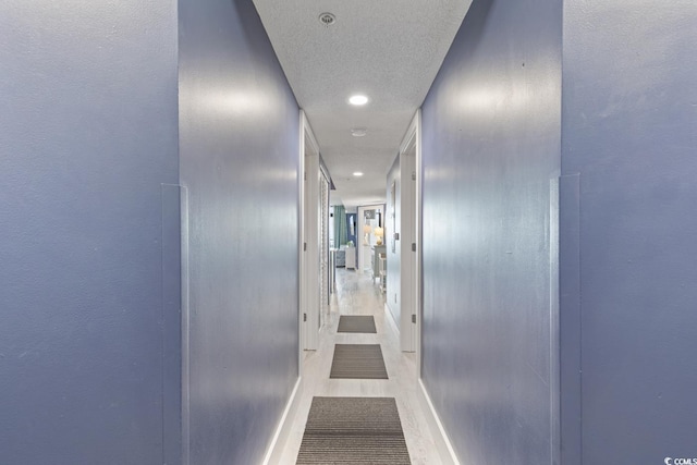 hallway featuring a textured ceiling