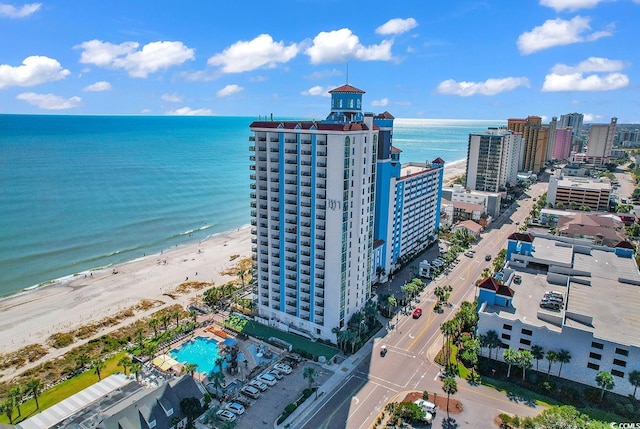 drone / aerial view featuring a beach view and a water view