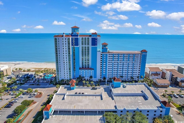 birds eye view of property featuring a water view and a beach view