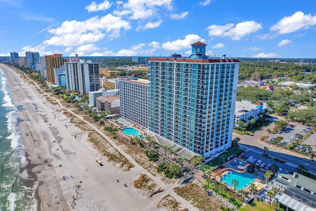 aerial view with a water view and a beach view