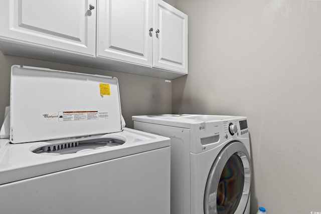 laundry area featuring cabinets and washing machine and clothes dryer