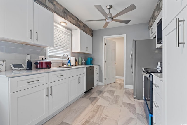 kitchen featuring white cabinetry, stainless steel appliances, and sink