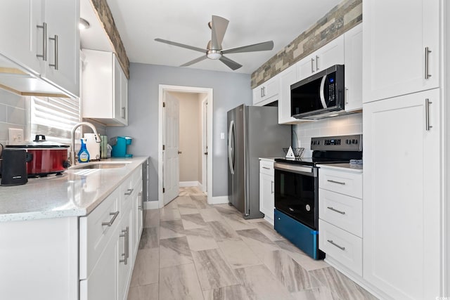 kitchen featuring ceiling fan, backsplash, sink, white cabinetry, and appliances with stainless steel finishes