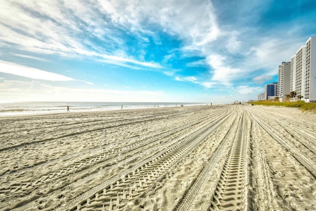 surrounding community with a water view and a beach view