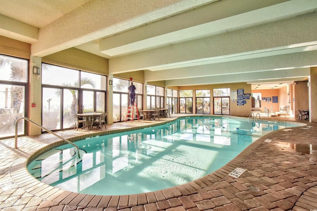 view of swimming pool with a patio and glass enclosure