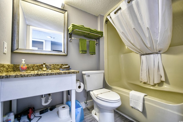 full bathroom featuring toilet, a textured ceiling, shower / bath combo, and vanity