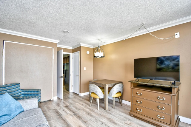 living room featuring light hardwood / wood-style floors, a textured ceiling, and crown molding