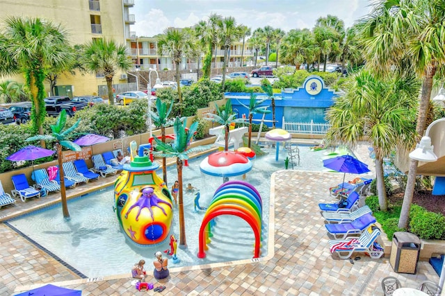 view of swimming pool featuring a playground