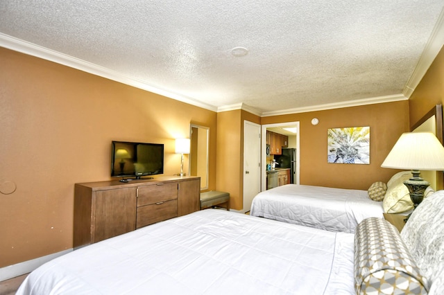 bedroom featuring ornamental molding, freestanding refrigerator, and a textured ceiling