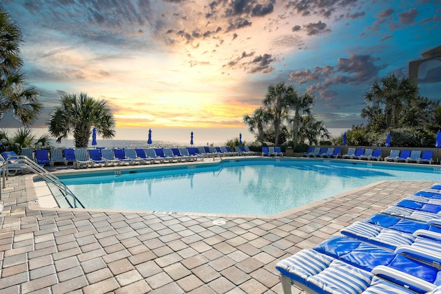 view of pool at dusk