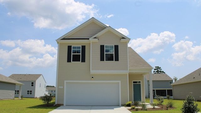 view of front of home with a garage and a front lawn