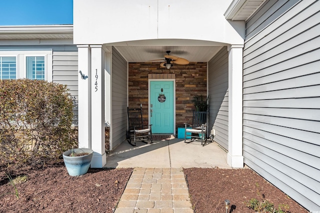 doorway to property featuring ceiling fan