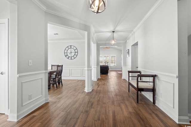 hallway with ornate columns, crown molding, and dark hardwood / wood-style floors