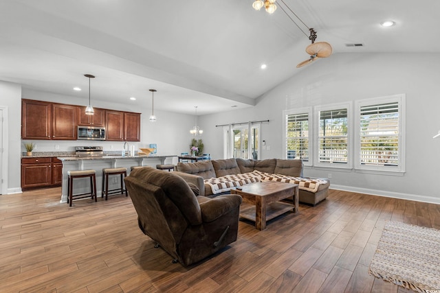 living room featuring lofted ceiling and sink