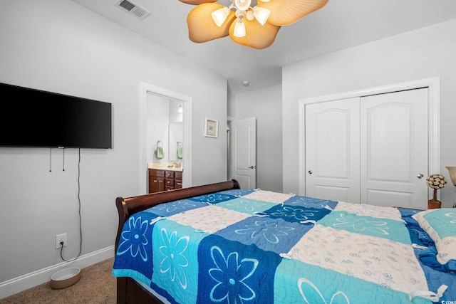 bedroom with ensuite bath, a closet, ceiling fan, and carpet flooring