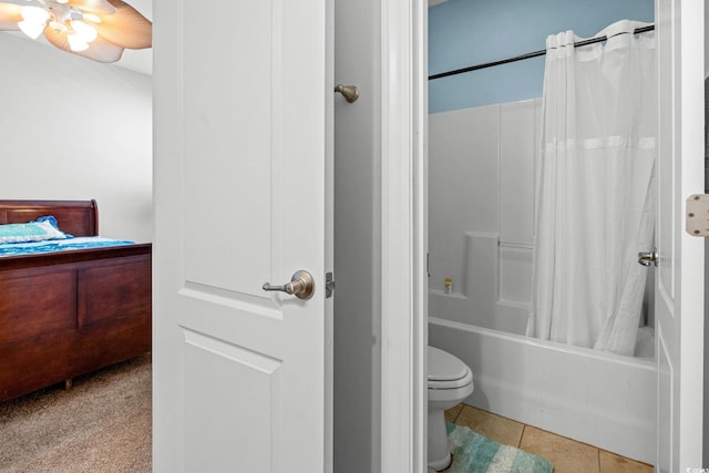 bathroom featuring toilet, shower / bathtub combination with curtain, and tile patterned flooring