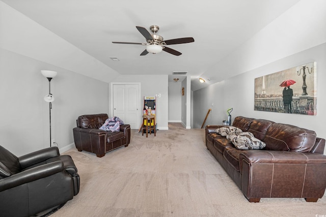 carpeted living room with ceiling fan and vaulted ceiling