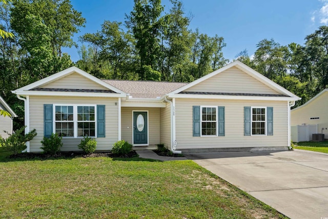 single story home with a front yard and central AC unit