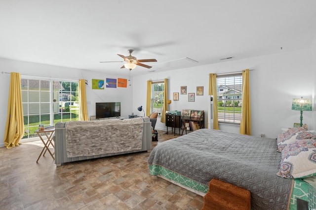 bedroom with multiple windows, access to exterior, and ceiling fan