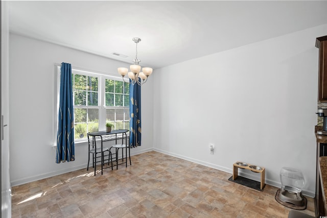 dining space featuring a notable chandelier