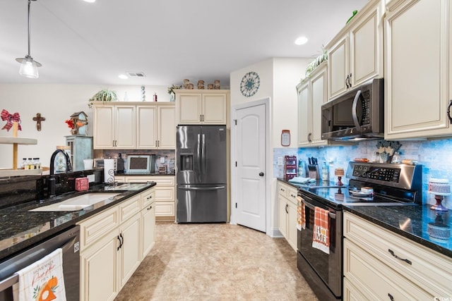 kitchen featuring cream cabinetry, stainless steel appliances, tasteful backsplash, decorative light fixtures, and sink