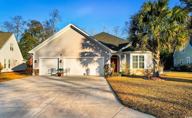 view of front of house with a garage and a front yard