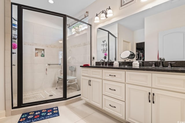 bathroom featuring tile patterned floors, vanity, and walk in shower