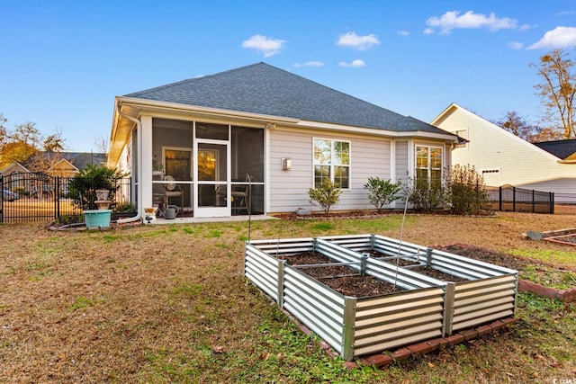 back of house with a lawn and a sunroom