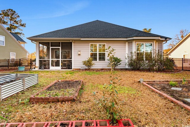 back of property with a sunroom