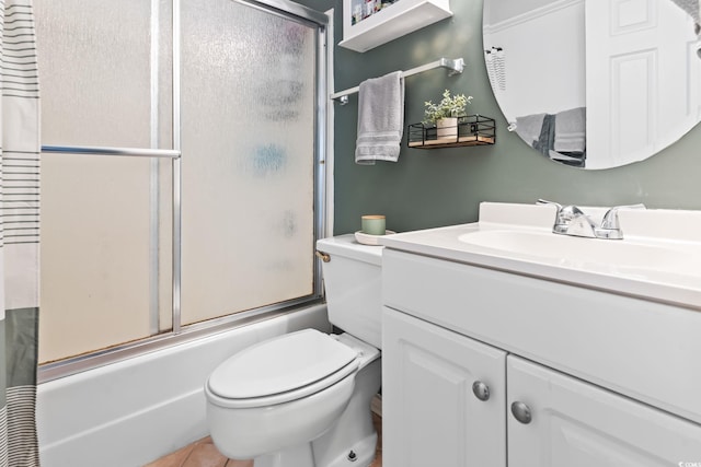 full bathroom with toilet, vanity, and shower / bath combination with glass door