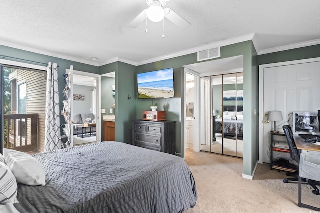 carpeted bedroom featuring ceiling fan, ensuite bathroom, a textured ceiling, and ornamental molding