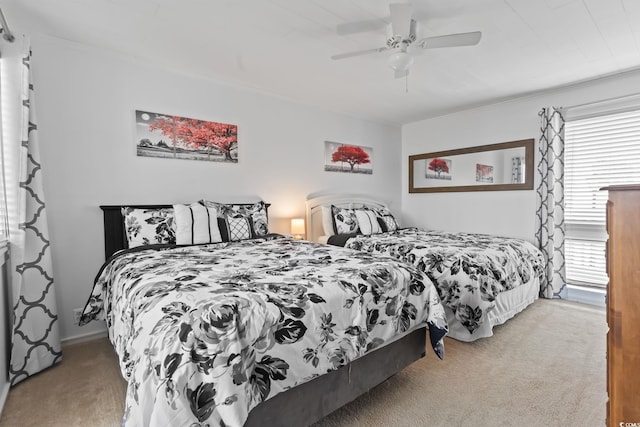 carpeted bedroom with ceiling fan and multiple windows