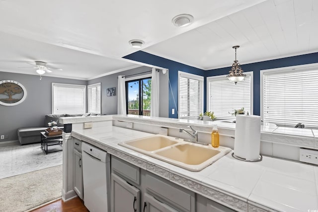 kitchen featuring gray cabinets, ceiling fan, white dishwasher, pendant lighting, and sink