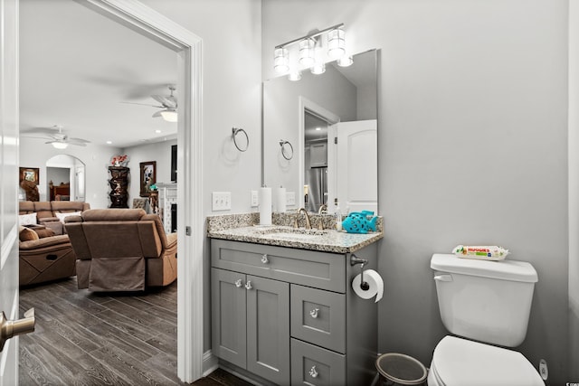 bathroom featuring ceiling fan, vanity, toilet, and hardwood / wood-style floors