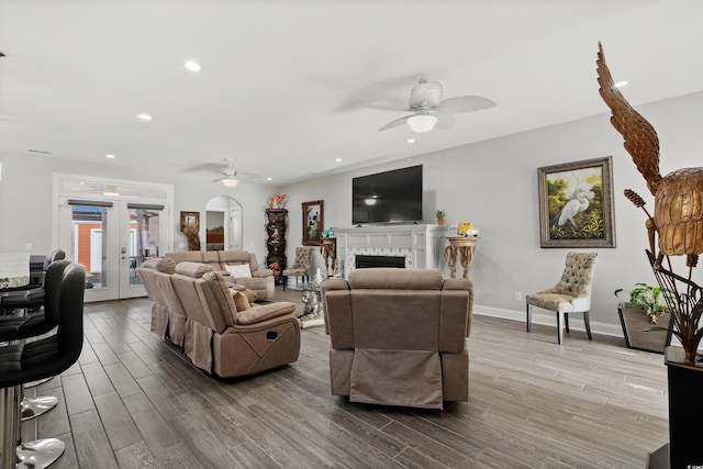 living room with hardwood / wood-style flooring, french doors, and ceiling fan