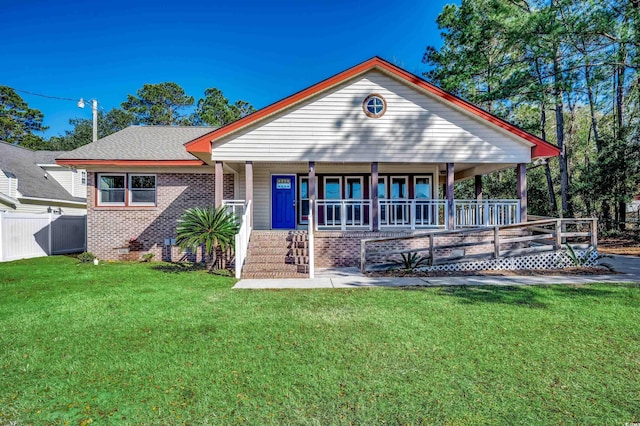 rear view of property with a lawn and covered porch