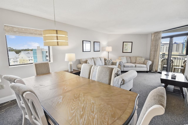 dining space featuring carpet and a wealth of natural light