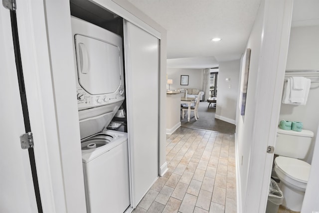 laundry area with stacked washer / drying machine