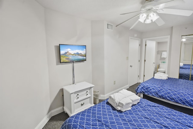 carpeted bedroom with ceiling fan and ensuite bathroom