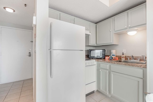 5905 S Kings Hwy Unit 908C, Myrtle Beach, SC 29575 - kitchen featuring sink, range, light tile patterned floors, white fridge, and white cabinets