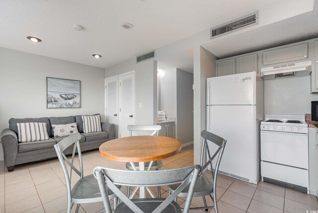 5905 S Kings Hwy Unit 908C, Myrtle Beach, SC 29575 - dining area featuring light tile patterned floors and a textured ceiling