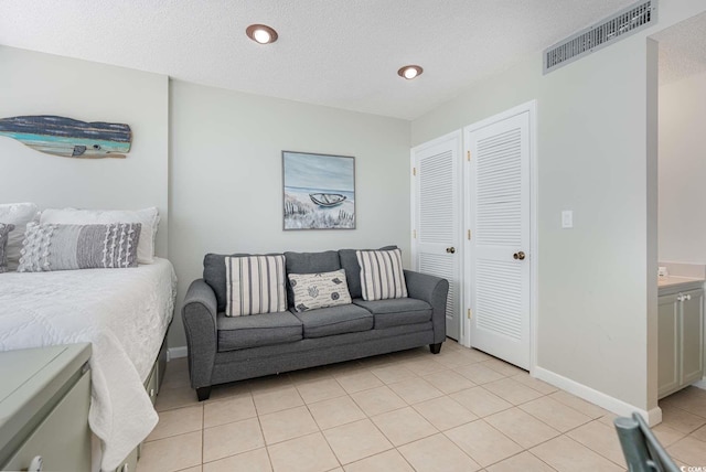 5905 S Kings Hwy Unit 908C, Myrtle Beach, SC 29575 - bedroom featuring a closet, a textured ceiling, and light tile patterned floors