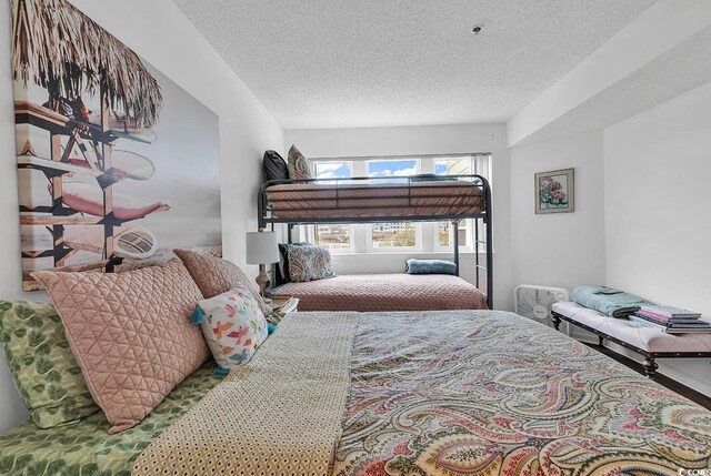 4560 Greenbriar Dr Unit 102-B, Little River, SC 29566 - bedroom with a textured ceiling