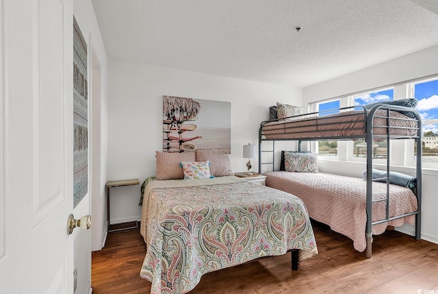 4560 Greenbriar Dr Unit 102-B, Little River, SC 29566 - bedroom featuring a textured ceiling and wood finished floors