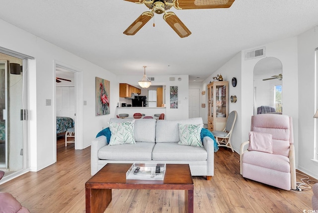 4560 Greenbriar Dr Unit 102-B, Little River, SC 29566 - living area with visible vents, light wood-type flooring, a ceiling fan, and baseboards