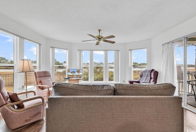 sunroom with plenty of natural light and ceiling fan