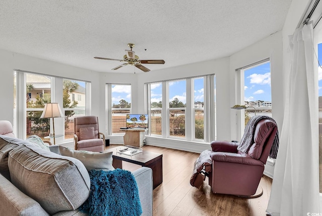 sunroom featuring ceiling fan