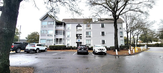 view of building exterior with uncovered parking