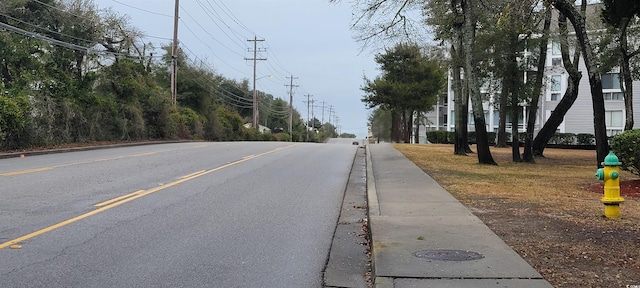 view of road featuring sidewalks and curbs