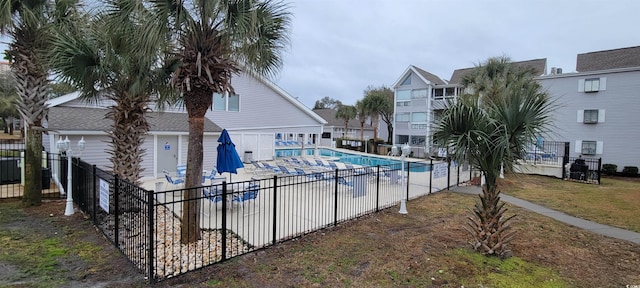 pool featuring a yard and fence